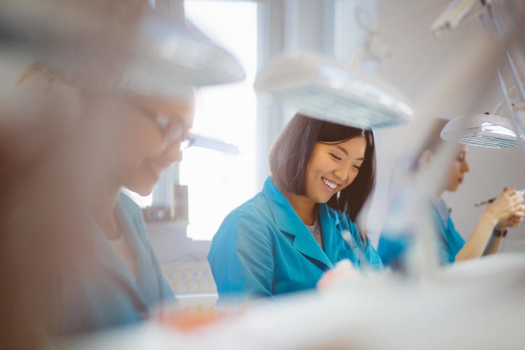 Dental technicians working in a dental laboratory on dental prosthetics